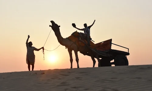camel safari at sunset time when desert changes its color in evening